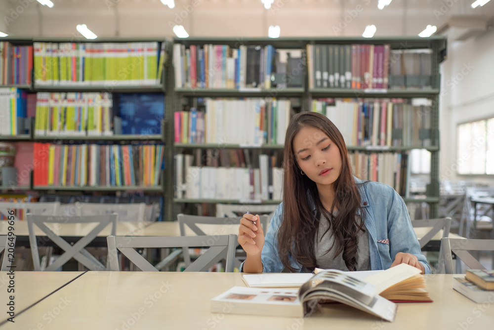 pretty woman happy to read and research in library pretty woman happy to read and research in library