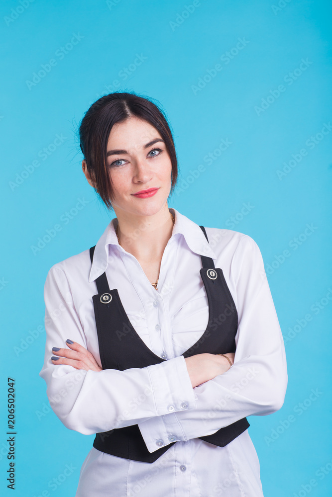 A pretty teenage brunette girl on blue background