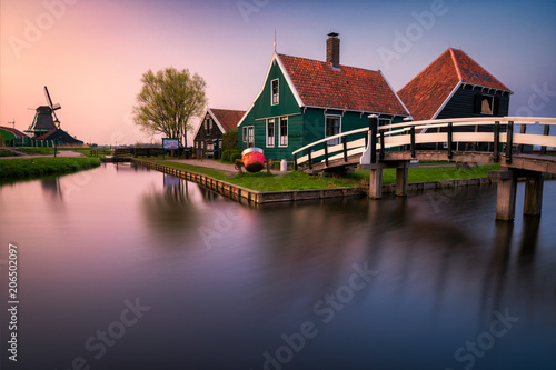 Sunset over historic houses and windmills of Zaanse Schans in the Netherlands