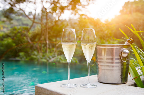 glasses of champagne near pool