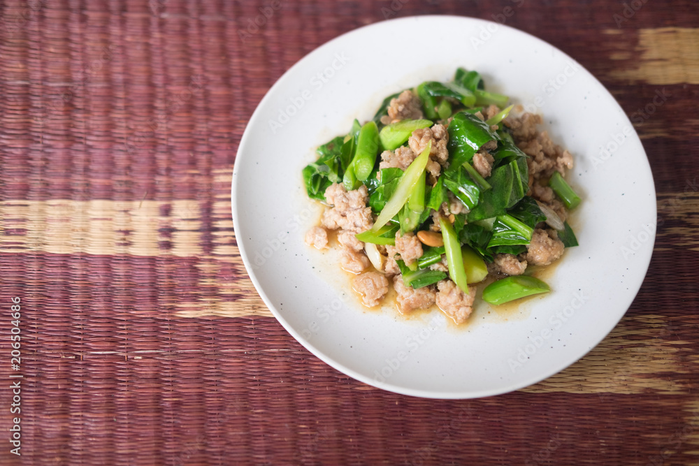 Stir fried kale with minced pork in white plate Stir fried kale with minced pork in white plate