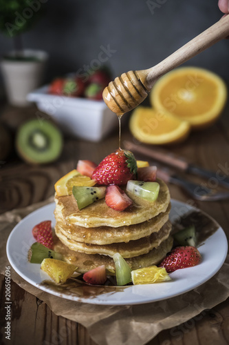 Buckwheat pancakes with berry fruit and honey.