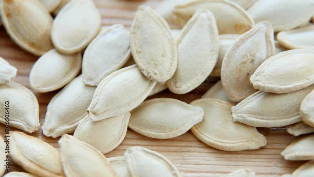 Pumpkin seeds on the wooden table Pumpkin seeds on the wooden table