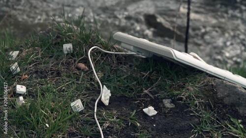 Broken Computer Keyboard. Broken computer keyboard in nature. The concept of technology's adverse impact on the world photo