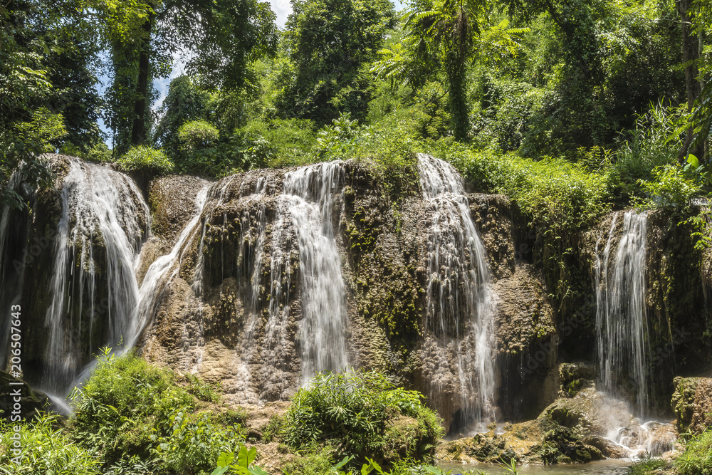 Obraz premium soft water of the stream in the natural park, Beautiful waterfall in rain forest