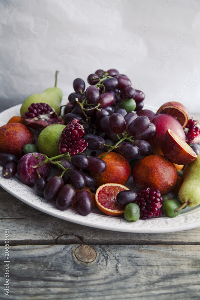 Fresh fruit platter with pomegranate, grapes and pears Fresh fruit platter with pomegranate, grapes and pears