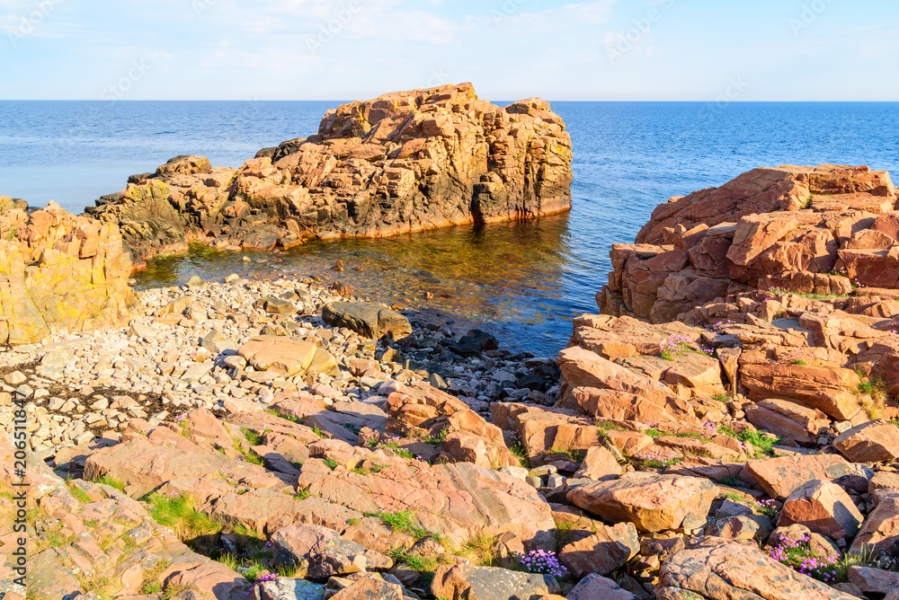 Rock formations on the coast of Hovs Hallar in the Bjare coast nature reserve, outside Bastad, Sweden. A sunny morning with calm sea.