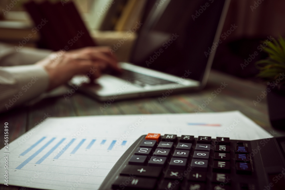 Business man calculate about cost and doing finance at office Business man calculate about cost and doing finance at office