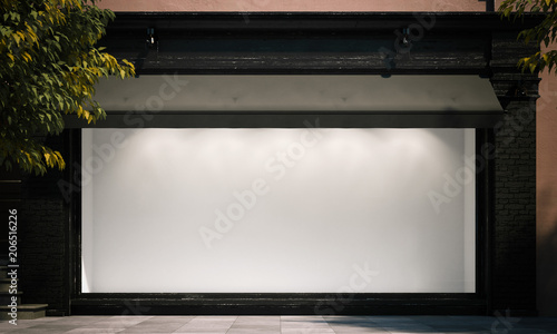 Foto Blank shop window in the night street with light on the frame