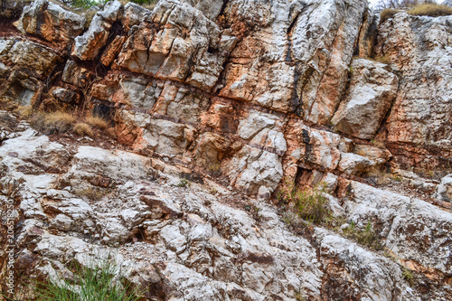 Texture of the rock. Large rocks exfoliate from the rock.