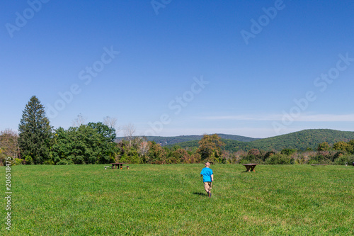 boy running in field © Elena