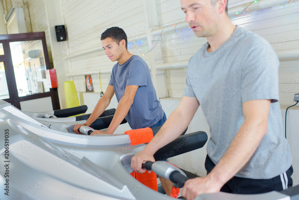 people running in machine treadmill at fitness gym people running in machine treadmill at fitness gym