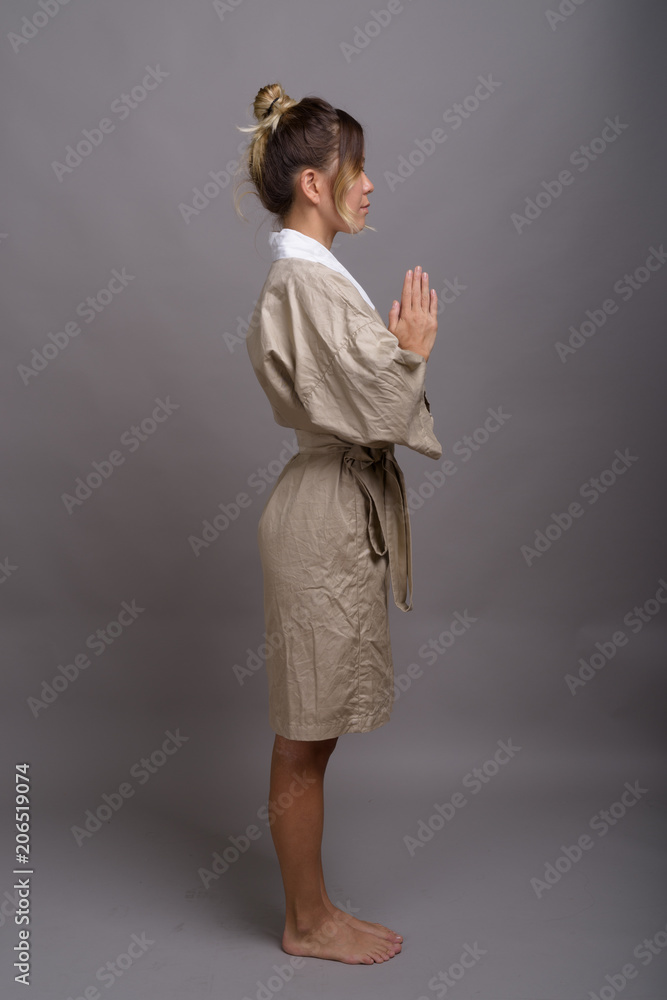 Young beautiful Kazakh woman against gray background Young beautiful Kazakh woman against gray background