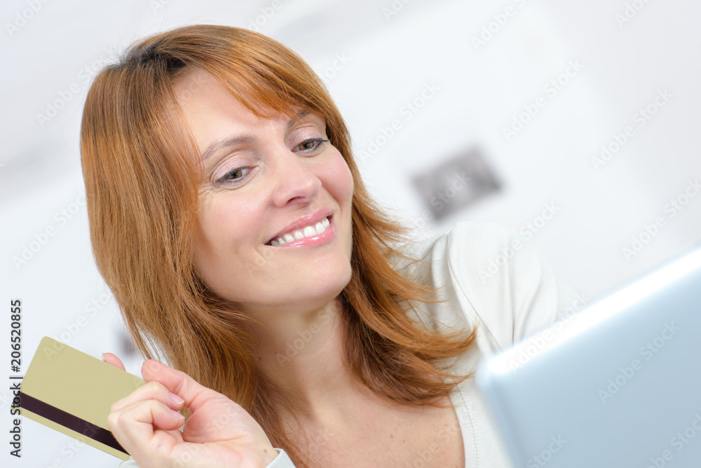 woman holding a credit card and buying online woman holding a credit card and buying online
