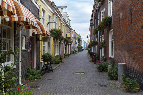 Fototapeta Naklejka Na Ścianę i Meble -  Narrow colorful street of the medieval Delft, Holland.