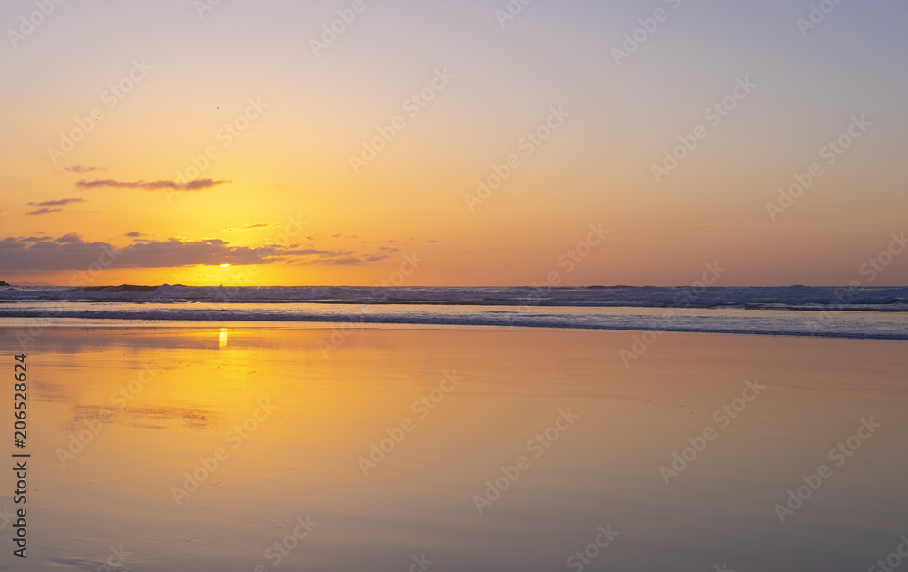 The beach in sunset time. Beautiful sky and reflex color on the beach. city of San Sebastian, Spain