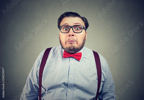 Confused chunky man in bow tie