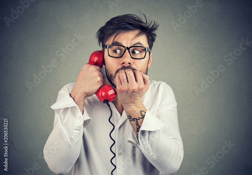 Stressed man speaking on phone