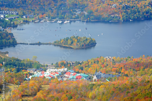 Fototapeta Naklejka Na Ścianę i Meble -  Lake Tremblant and Mont-Tremblant village in fall with fall foliage, from top of Mont Tremblant, Quebec, Canada.