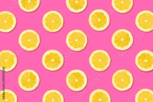 Colorful fruit pattern, Lemon slices on a pastel pink background. Top view.