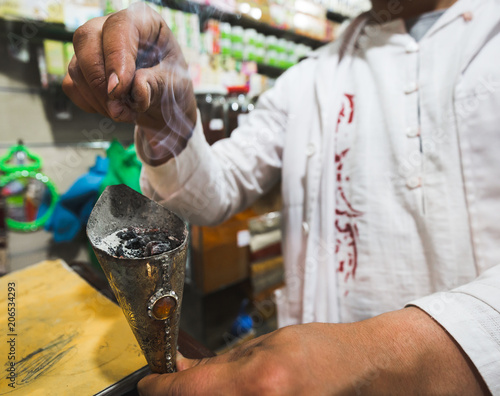 man making incense in a spice shop in Marrakech, Morocco