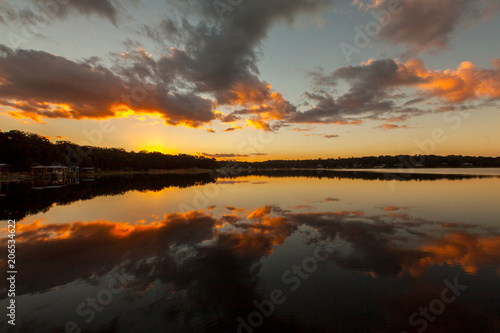 Stunning Orange Sunset Over a Still Lake © Michael