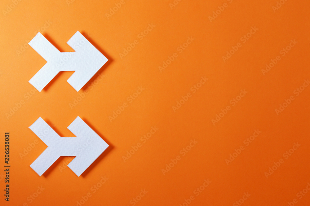 Fototapeta premium two arrows on orange background