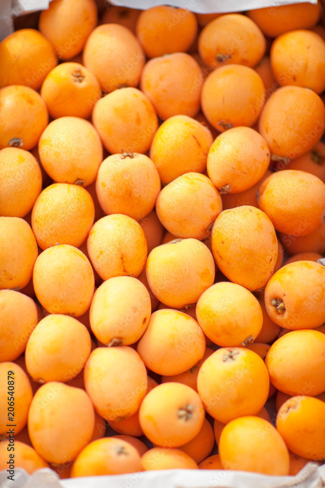fresh delicious yellow nisperos, on the weekly market, can be used as background