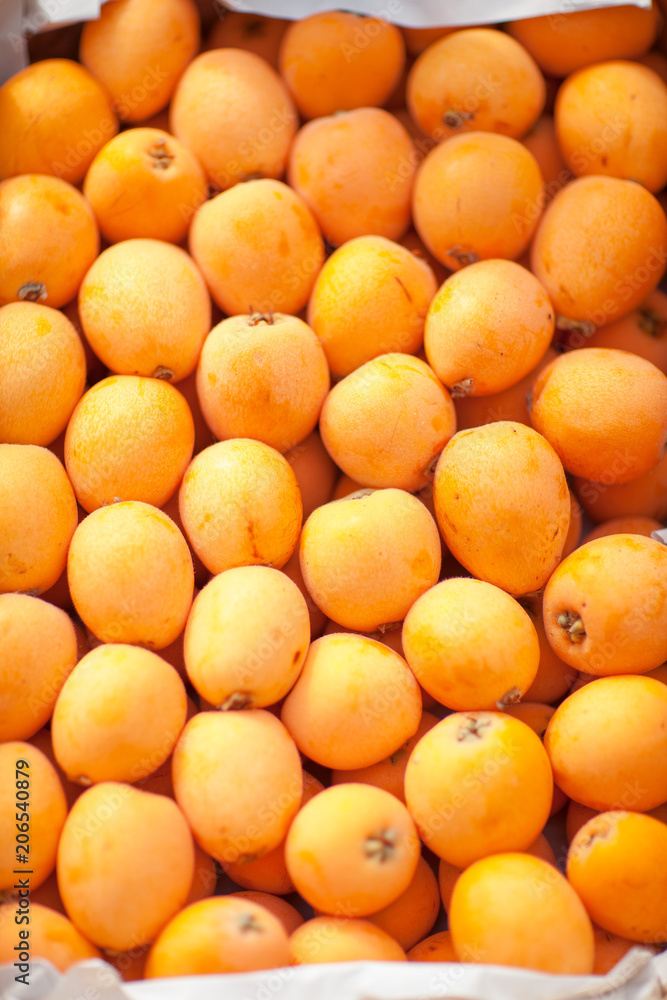 fresh delicious yellow nisperos, on the weekly market, can be used as background fresh delicious yellow nisperos, on the weekly market, can be used as background