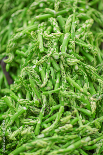 fresh green asparagus tips decorated at the weekly market, can be used as background
