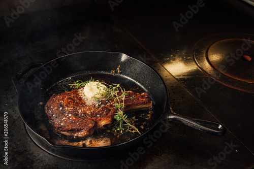 Cooking steak in a cast iron pan.