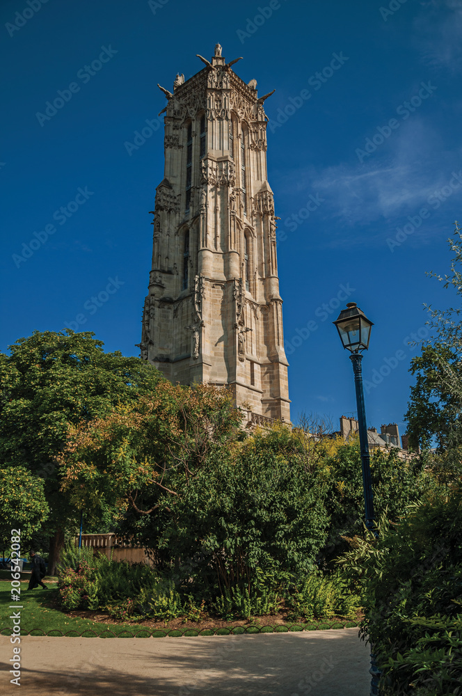 Flamboyant Gothic Saint-Jacques Tower and blue sky in the City Center of Paris. Known as the “City of Light”, is one of the most impressive world’s cultural center. Northern France. Retouched photo.