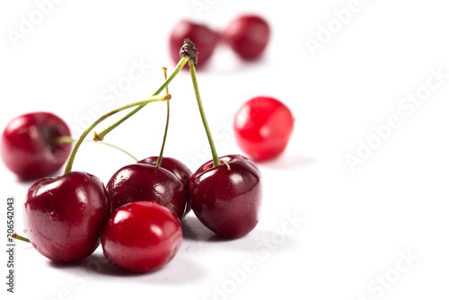 Ripe red cherry on a white background.