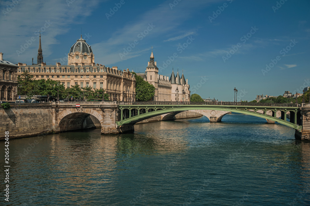 Bridge over the Seine River and the Conciergerie building with sunny blue sky at Paris. Known as the “City of Light”, is one of the most impressive world’s cultural center. Northern France.