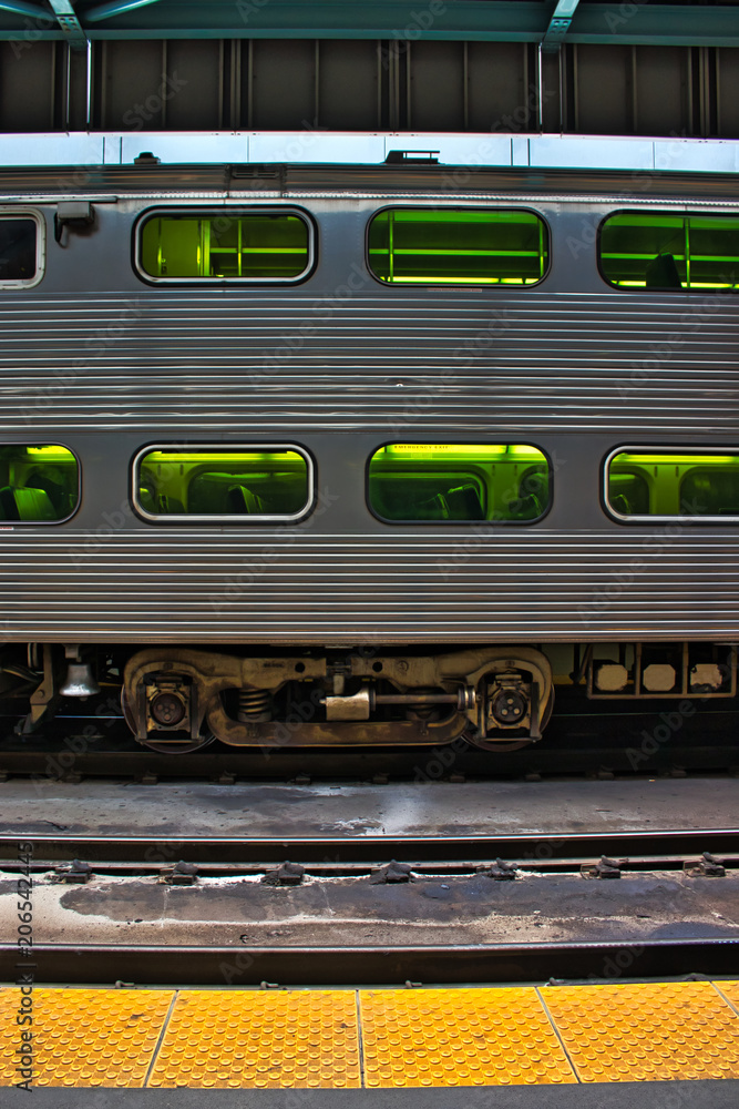 Train sitting on tracks seen from platform in train station. Train sitting on tracks seen from platform in train station.