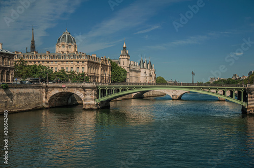 Bridge over the Seine River and the Conciergerie building with sunny blue sky at Paris. Known as the “City of Light”, is one of the most impressive world’s cultural center. Northern France.