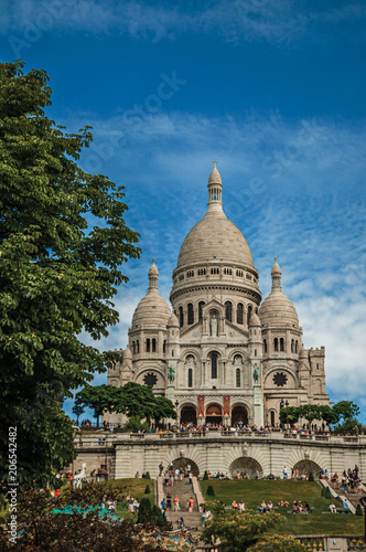 Staircase, domes and facade of the Basilica of Sacre Coeur at the Montmartre district in Paris. Known as the “City of Light”, is one of the most impressive world’s cultural center. Northern France. © Celli07