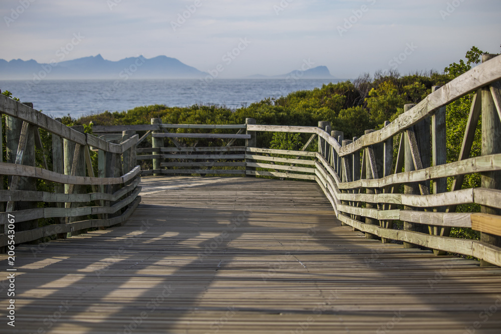 Wooden walkway at Sunrise on Boulders Beach, Simonstown, Cape Town, South Africa. Wooden walkway at Sunrise on Boulders Beach, Simonstown, Cape Town, South Africa.