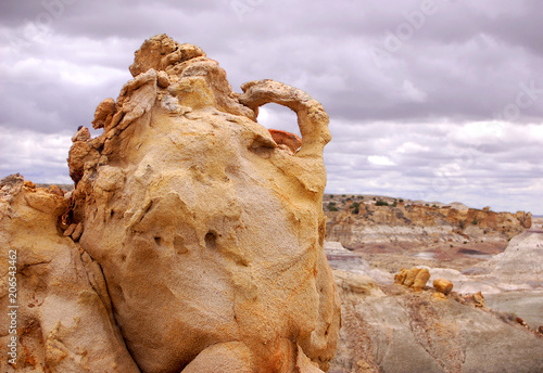 Pocked and weathered sandstone formation with arch in the Bisti Badlands of North West New Mexico.