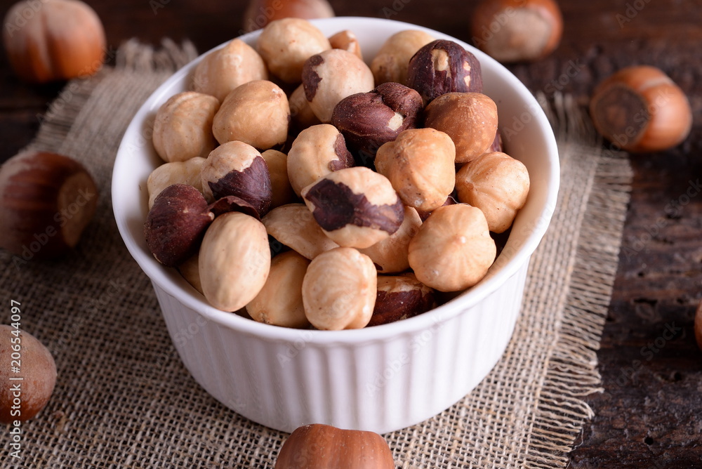 Bowl with toasted hazelnuts on a table Bowl with toasted hazelnuts on a table