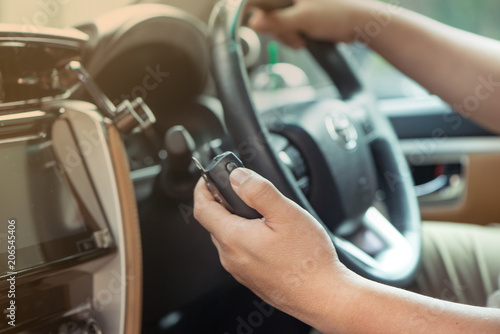Man hand on Mobile radio in his car photo