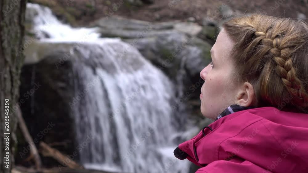 Young female in nature with waterfall background 4k
Young female in nature with waterfall background 4k