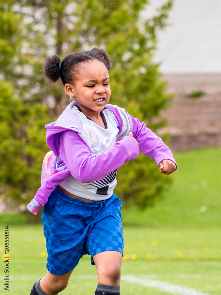 A young girl is learning how to play soccer A young girl is learning how to play soccer