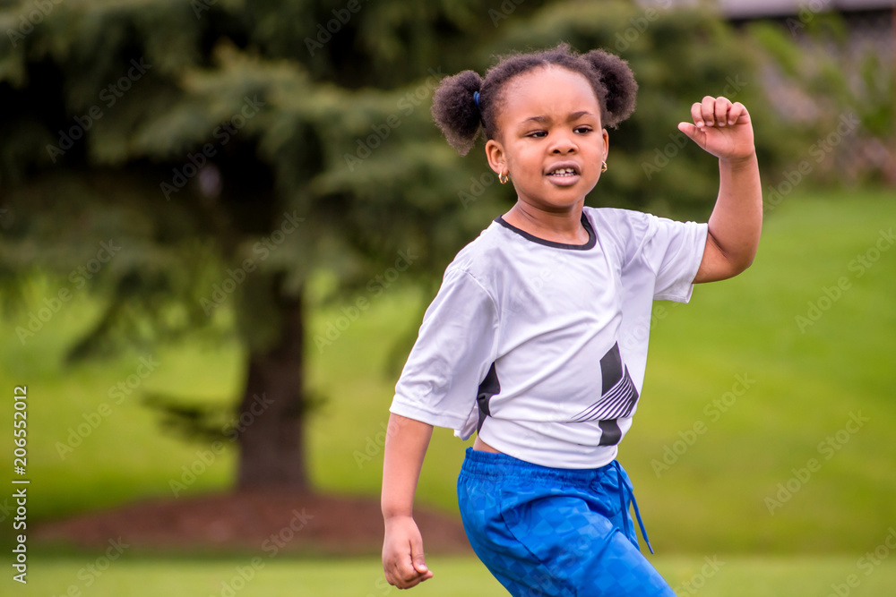A young girl is learning how to play soccer A young girl is learning how to play soccer