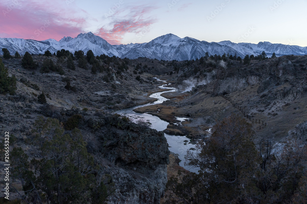 Pink sunrise colors bask the Sierra Nevada in California from the Hot Creek