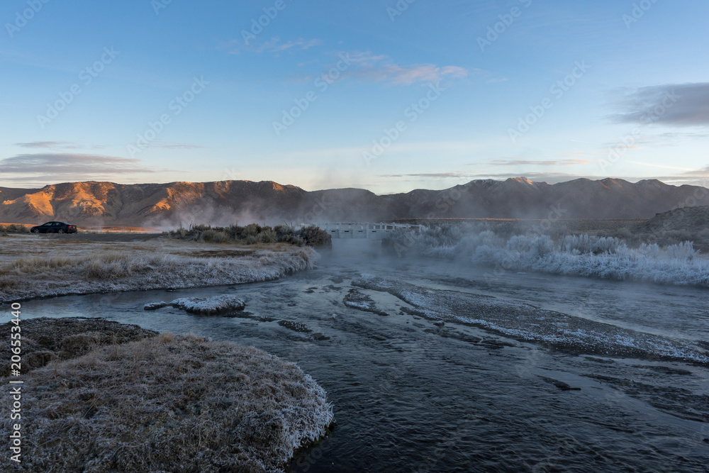 Sunrise over a misty hot creek in the winter