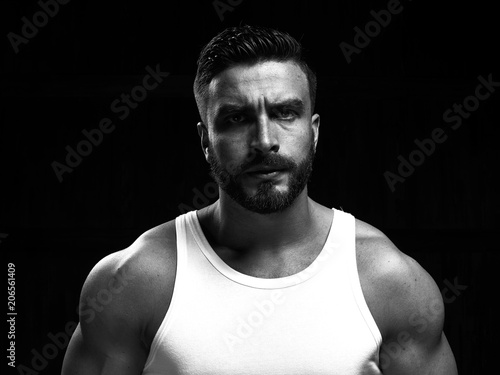 Monochrome portrait of a strong man with a beard. He looks at the camera with different emotions. 
