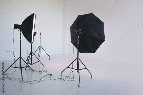 An empty photo Studio with white cyclorama, photo equipment is ready to shoot. 