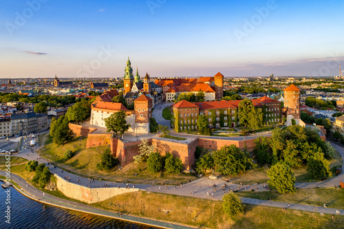 Poland. Krakow skyline with Wawel Hill, Cathedral, Royal Wawel Castle, defensive walls,Vistula riverbank, park, promenade, walking people. Old city in the background photo