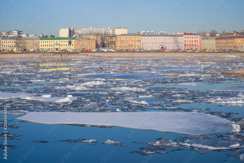 Spring ice drift on the background of Sinopskaya embankment. Saint-Petersburg, Russia